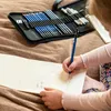A child is drawing in a sketchbook with a set of pencils. Náhled obrázku produktu