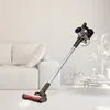 A cordless stick vacuum cleaner is shown in a bright, modern living room setting. Produktbild-Vorschau