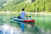 A person sits on a stand-up paddleboard on a clear lake, with a forested mountain in the background. Voir les images du produit