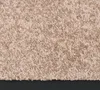 A close-up view of a beige carpet. Voir les images du produit