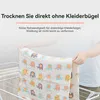 A person is holding up a piece of fabric with elephant prints on a drying rack. Produktbild-Vorschau