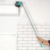 A person is using a telescopic broom to clean the top of an air conditioner unit. Náhľad obrázku produktu