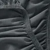 A close-up view of dark gray fabric with elastic gathering. Produktbild-Vorschau