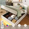 A bed with its storage open, showing stored items, and a remote control with LED lighting options displayed below. Voir les images du produit