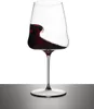 A wine glass with red wine splashing inside, set against a white and gray background. Produktbild-Vorschau