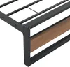 Close-up view of a bed frame corner, showing the metal frame and a wood-look insert. Produktbild-Vorschau