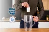 A person is inserting a filter into a water pitcher. Produktbild-Vorschau