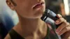 A close-up shot of a person using an electric shaver on their face. Podgląd zdjęcia produktu