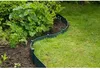 A green garden border separating a lawn from a garden bed with plants. Produktbild-Vorschau
