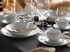 A table setting with white porcelain dinnerware, gold cutlery, and decorative elements. Podgląd zdjęcia produktu