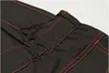A close-up view of black fabric with red stitching, showing gathered material and seams. Produktbild-Vorschau