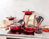A collection of red cookware and kitchen utensils arranged on a countertop. Podgląd zdjęcia produktu