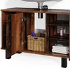 A close-up view of a wooden bathroom vanity cabinet with an open door, revealing a basket and shelves with toiletries and towels. Produktbild-Vorschau