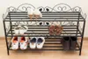 A black metal shoe rack with various shoes on its shelves. Produktbild-Vorschau