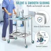 A person in blue scrubs pushes a stainless steel medical cart in a hospital or clinic setting. Produktbild-Vorschau