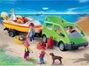 A family is on a beach with a green van and a boat on a trailer. Podgląd zdjęcia produktu