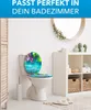 A toilet with a decorative seat cover in a bathroom setting. Produktbild-Vorschau