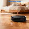 A robot vacuum cleaner is cleaning a wooden floor in a bedroom while a person sleeps in the bed. Produktbild-Vorschau