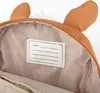 Close-up view of the inside of a child's backpack, showing a name tag and the lining. Anteprima dell’immagine prodotto