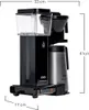 A black and silver coffee maker with dimensions indicated by measurement lines. Produktbild-Vorschau