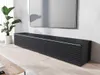 A modern living room with a black TV stand and a large TV mounted on the wall. Náhled obrázku produktu