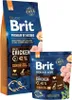 Two bags of Brit Premium By Nature dog food, one large and one small, are shown against a white background. The bags are blue with orange accents and feature images of chicken and herbs. Voir les images du produit