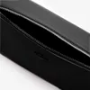 A close-up view of an open black bag with a zipper. Voir les images du produit