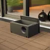 A black insulated cat house with a circular opening is placed on a wooden deck next to a large glass door. Produktbild-Vorschau