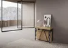 A console table with a lamp and artwork displayed on it, placed in a modern room with large glass doors opening to a mountain view. Podgląd zdjęcia produktu