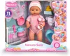 A Nenuco Sara doll in its retail packaging, surrounded by accessories and feature callouts. Produktbild-Vorschau
