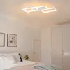 A bedroom with a bed, wardrobe, and a modern ceiling light. Produktbild-Vorschau