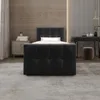 A bedroom scene with a bed, nightstand, and vanity. Produktbild-Vorschau