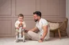 A father and son are playing with a ride-on toy. Náhľad obrázku produktu