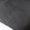 A close-up view of a black fabric surface with many water droplets on it, showing its water-repellent properties. Anteprima dell’immagine prodotto