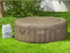 An inflatable hot tub and its pump unit are set up on a grassy lawn. Produktbild-Vorschau