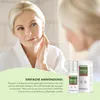A woman applying cream to her face in front of a mirror, with the product packaging visible. Produktbild-Vorschau