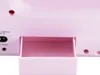 A close-up view of the back of a pink sewing machine, showing a small open storage compartment and various ports. Produktbild-Vorschau