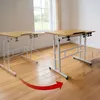 Two adjustable height desks are shown in a room with wooden floors and a window in the background. A red arrow indicates movement or adjustment. Produktbild-Vorschau