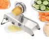 A mandoline slicer with a potato being sliced, surrounded by plates of sliced vegetables. Produktbild-Vorschau