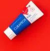 A tube of Curaprox kids toothpaste is placed diagonally on a red background. Anteprima dell’immagine prodotto