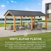 A wooden carport with a dark metal roof, furnished with outdoor seating and a dining set, situated on a paved patio next to a lawn and a body of water. Náhled obrázku produktu