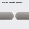 Two Beats Pill speakers are shown side-by-side, with text above indicating they can be synced. Náhled obrázku produktu