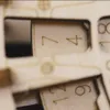 A close-up view of a wooden 3D puzzle with numbers etched onto it. Anteprima dell’immagine prodotto