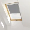 A close-up view of a skylight window with a gray roller blind partially lowered. Produktbild-Vorschau