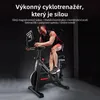 A man is riding an exercise bike in a dark room. Náhľad obrázku produktu