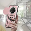 A hand holding a pink phone case with a camera cover and a ring holder, with a blurred background of a room. Produktbild-Vorschau