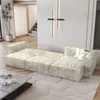 A modern living room with a sectional sofa, coffee table, and a plant. Produktbild-Vorschau