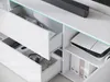 A close-up view of a white, high-gloss media console with drawers and shelves. Náhled obrázku produktu