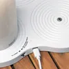 A close-up view of a white Sirius LED candle charger with a USB cable plugged in. Produktbild-Vorschau