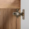 Close-up of a cabinet hinge on a wooden cabinet door. Anteprima dell’immagine prodotto